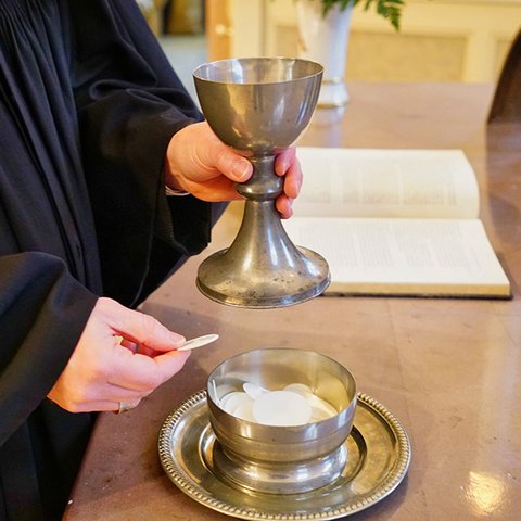 Pfarrer mit Altar und Abendmahl
