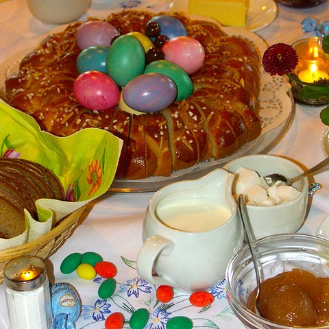 Gedeckte Ostertafel mit Osterkranz und bunten Eiern