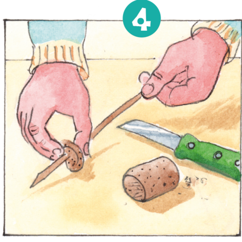 Hände spießen Korkenstückchen auf Holzstäbchen.