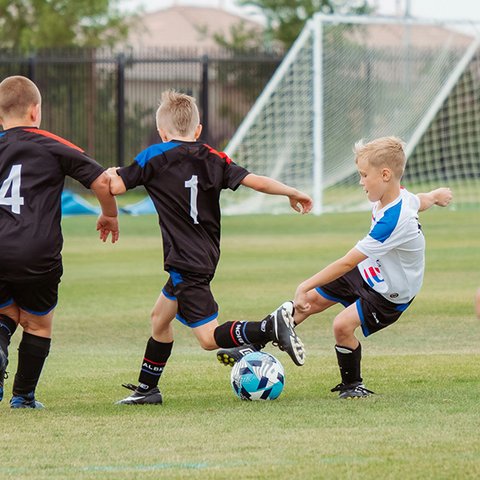 Drei Jungs beim Fußballspielen